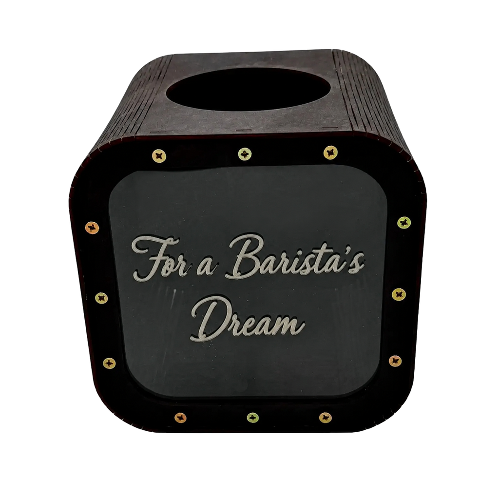 Dark wooden tip savings box with a rounded top, coin slot, transparent front panel, gold screws, and engraved text “For a Barista’s Dream”.