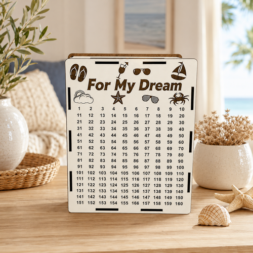 White wooden “For My Dream” vacation savings piggy bank standing on a wooden table in a cozy coastal-style home interior with seashells, plants, and soft natural light.