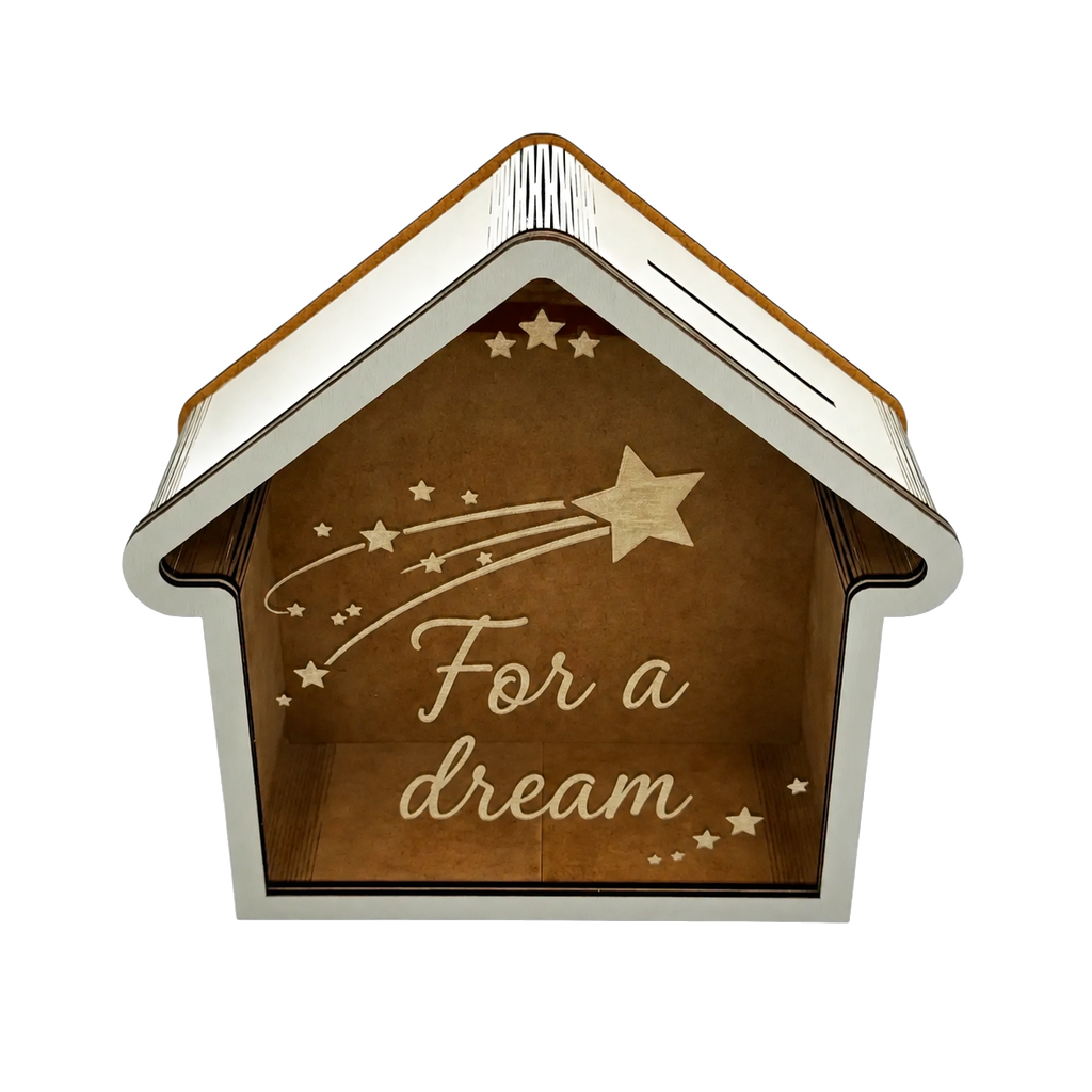 House-shaped wooden savings box with a transparent front panel, coin slot, white frame, star decorations, and “For a dream” engraving.